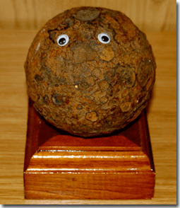 Exhibit A: A cannonball I have in my office, resting on a stand a friend of mine made me. I put the eyes on it last week. (Also, the friend who made the stand is also a singer-songwriter, so he can do anything, it seems. He's not on Facebook). 