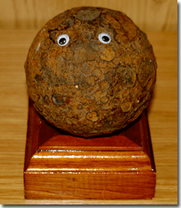 Exhibit A: A cannonball I have in my office, resting on a stand a friend of mine made me. I put the eyes on it last week. (Also, the friend who made the stand is also a singer-songwriter, so he can do anything, it seems. He's not on Facebook).